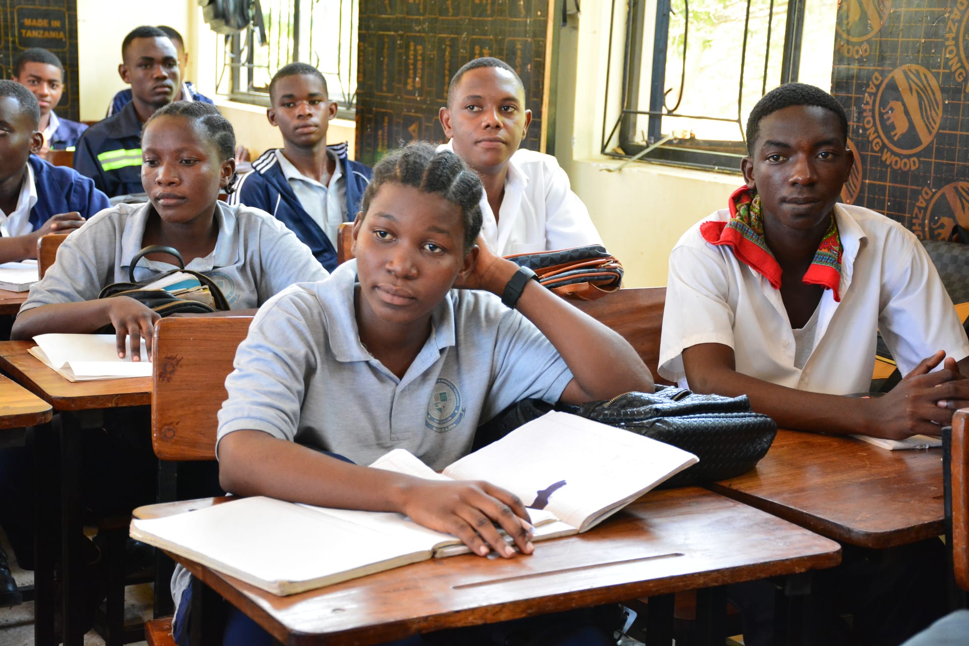 Students in a tailoring class learning garment construction techniques